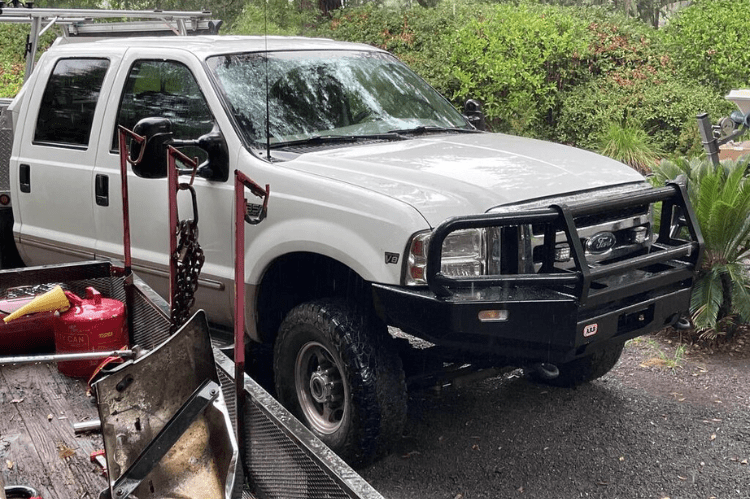 Ford Superduty truck  showcasing  ARB deluxe durable black powder-coated front bumper with grille guard.