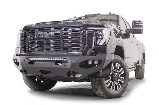 Front view of a black GMC Sierra 2500/3500 truck featuring a large grille and Fab Fours Matrix front bumper, winch ready.