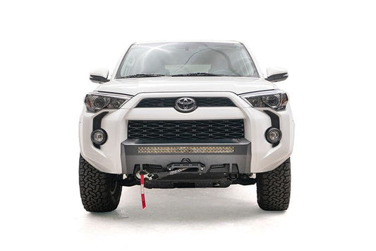 White Toyota 4Runner's front end showcasing a Fab Fours hidden bumper, winch-ready, compatible with models from 2014 to 2024.