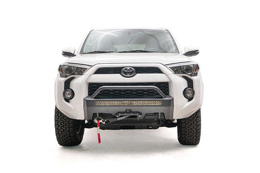 White Toyota truck with a Fab Fours hidden front bumper pre-runner and winch guard, suitable for 2014-2024 4Runners.