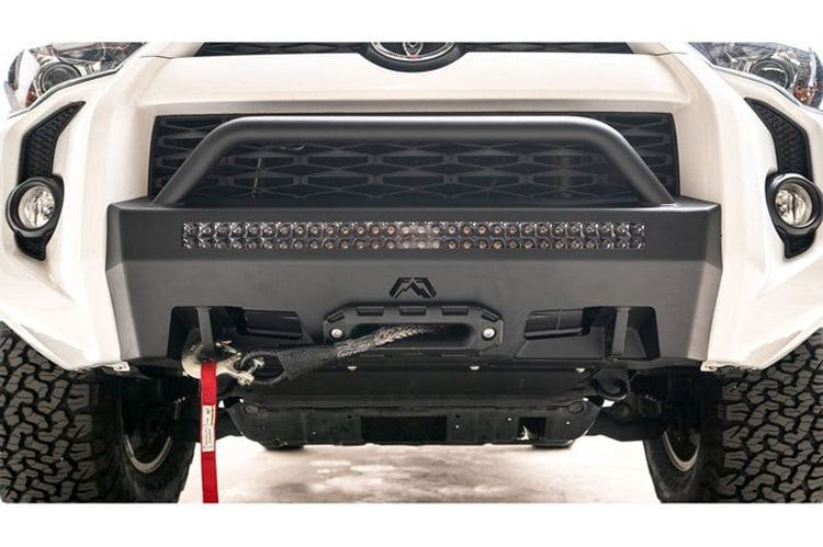 White Toyota truck with a Fab Fours hidden front bumper pre-runner and winch guard, suitable for 2014-2024 4Runners.