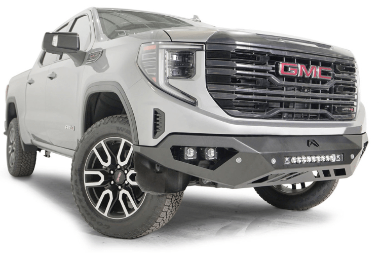 Silver GMC Sierra truck's front end showcasing the Fab Fours Vengeance bumper, model GS23-D5851-1, for 2022-2025