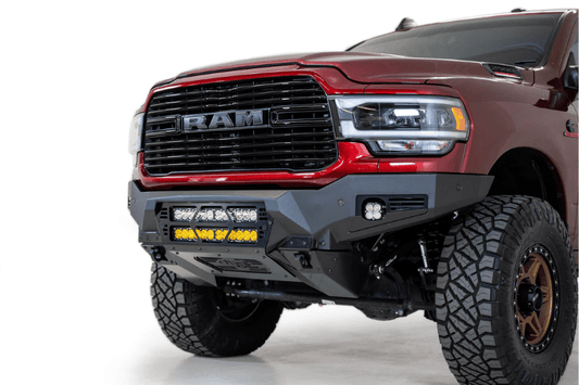 The front of a red Ram truck equipped with a Bomber Black front bumper, ADD F560012140103, compatible with 2019-2023 Dodge Ram models