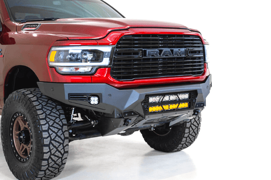 The front of a red Ram truck equipped with a Bomber Black front bumper, ADD F560012140103, compatible with 2019-2023 Dodge Ram models