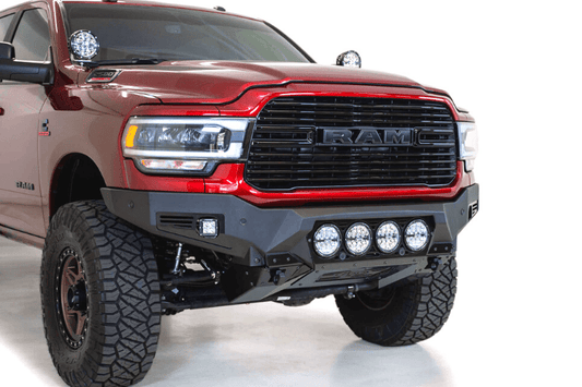 Front view of a red Ram truck featuring the ADD F560014110103 Bomber Black front bumper for Dodge Ram 2500/3500 models