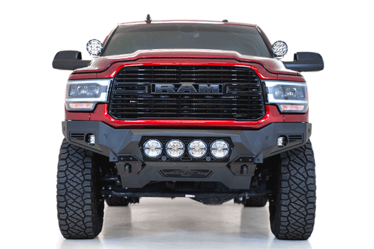 Front view of a red Ram truck featuring the ADD F560014110103 Bomber Black front bumper for Dodge Ram 2500/3500 models