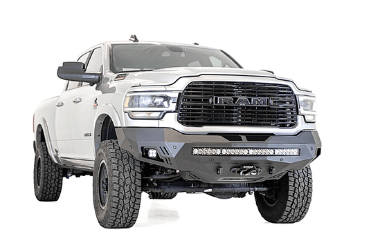 A white Dodge Ram 2500/3500 truck featuring a prominent ADD Stealth Fighter front bumper and winch mount, F561423030103