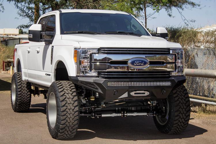 Front view of a White Ford F250/F350 Superduty truck featuring a black ADD F161202860103 Stealth Fighter bumper with a light bar, winch ready