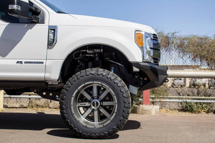 Front view of a White Ford F250/F350 Superduty truck featuring a black ADD F161202860103 Stealth Fighter bumper with a light bar, winch ready