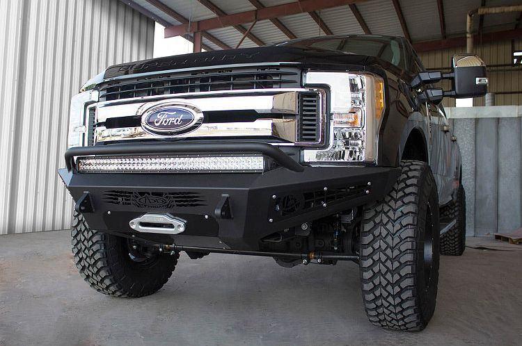 Black Ford F250/F350 Superduty pickup truck equipped with ADD Honeybadger front bumper F167382840103, suitable for winches and additional light mounts